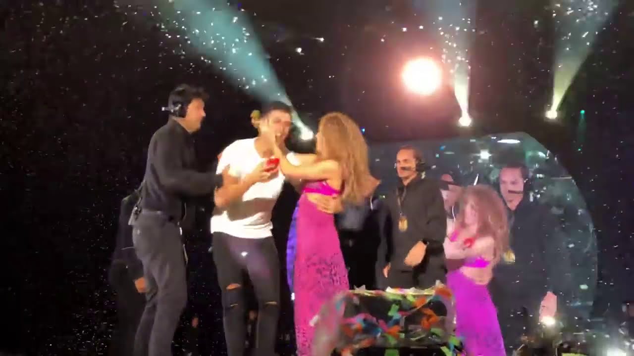 A maniac fan of Shakira breaks into the stage to take a selfie with Shakira live