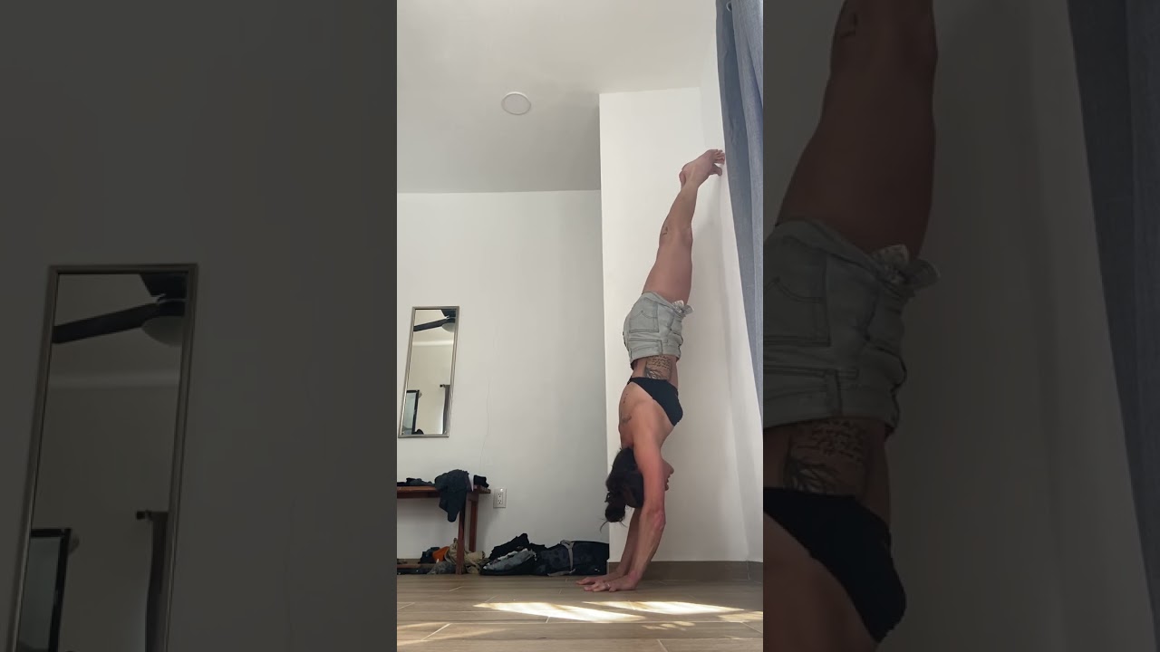 Belly to wall handstand