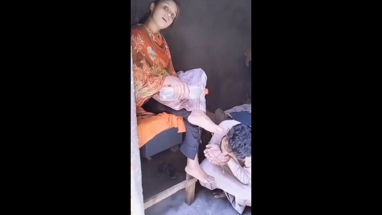 boy is drinking the water to wash the girl's feet
