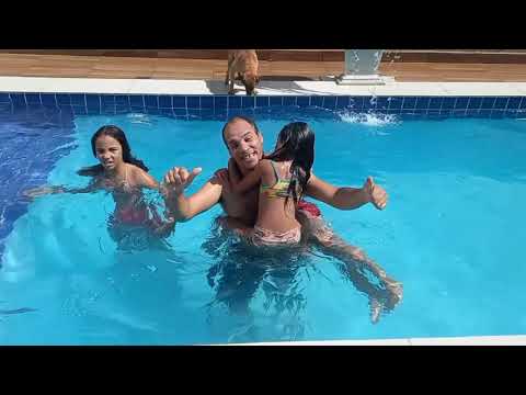 Brincando na piscina, empurrados o papai na piscina