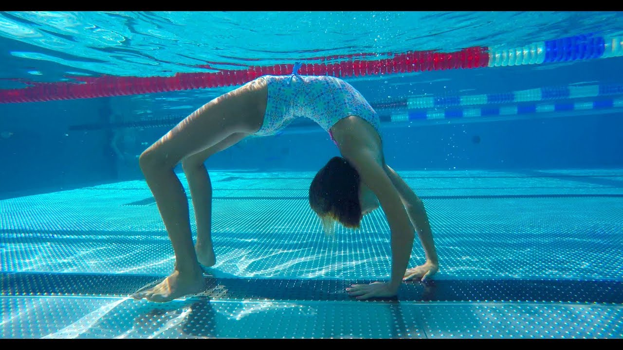 Carla underwater doing underwater gymnastics