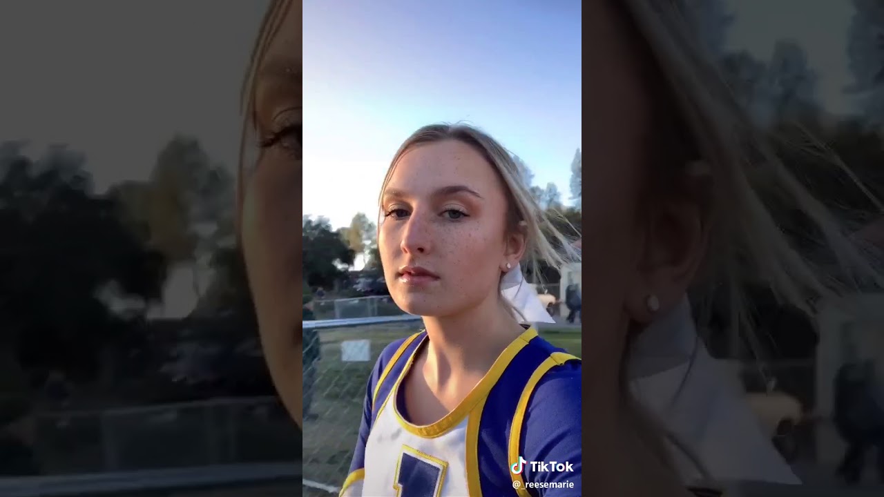 Cheerleader kisses other cheerleaders