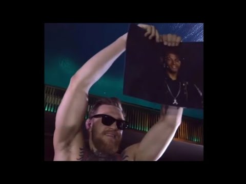 Conor McGregor bouncing on top of a packed bar in Rio de jeneiro and ripping up a photo of Jose Aldo
