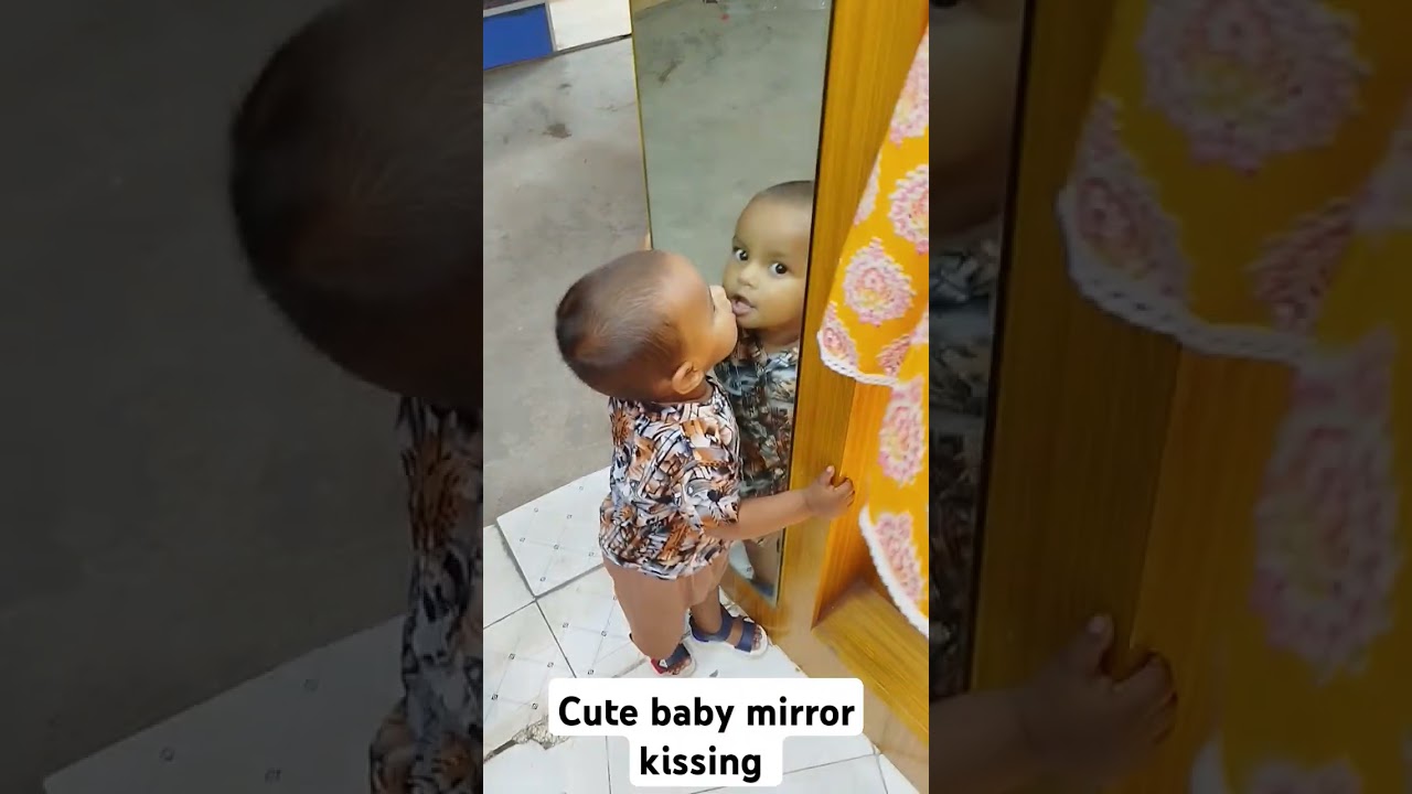 Cute baby mirror kissing