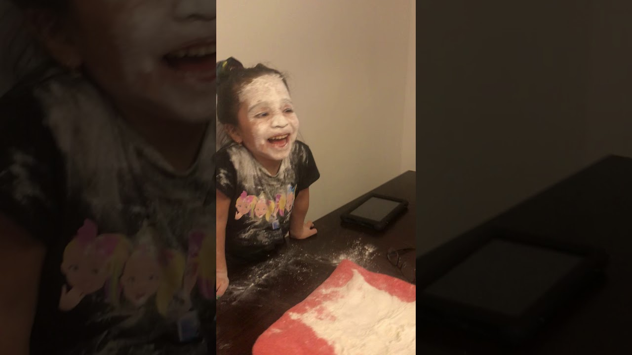 Dad and daughter playing Rock, Paper, Scissors and loser has to put their face in flour.