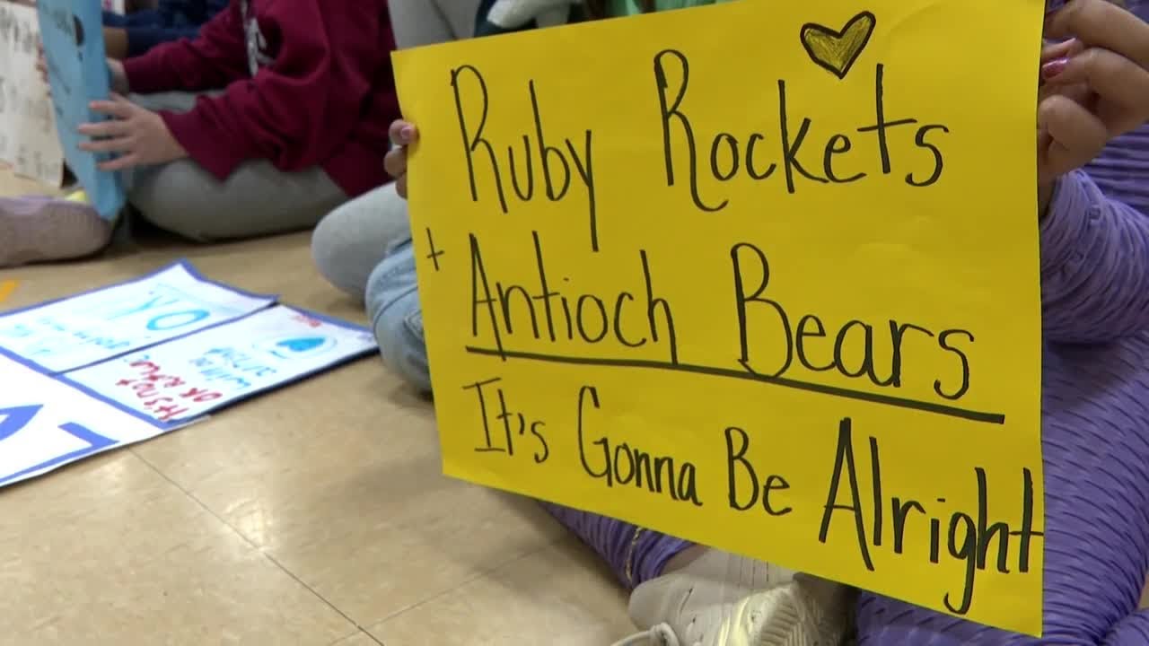 Elementary school students sing Antioch High School a message of love and healing
