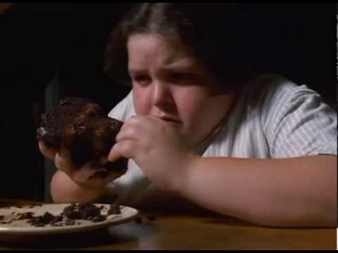 Fat kid eats a chocolate cake