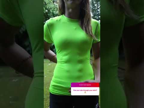FBB Magdalena flexing shredded abs through shirt