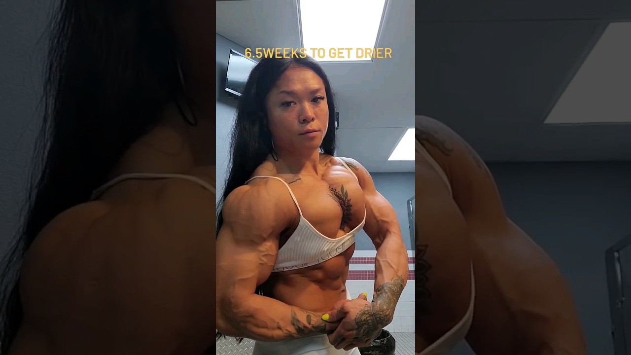 FBB Marilyn Yee Tong flexing shredded pecs and biceps