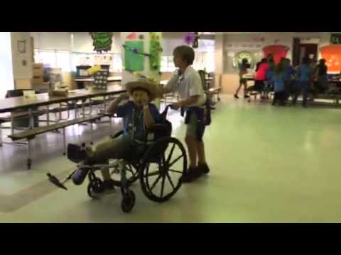 February 27 Colton at CIE aftercare wheeling a friend in a wheelchair