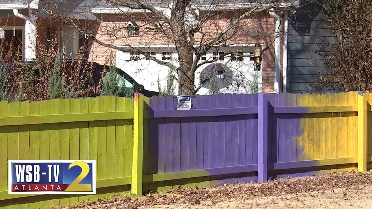 Fence fight: Woman paints fence neon colors after neighbor complains to county | WSB-TV