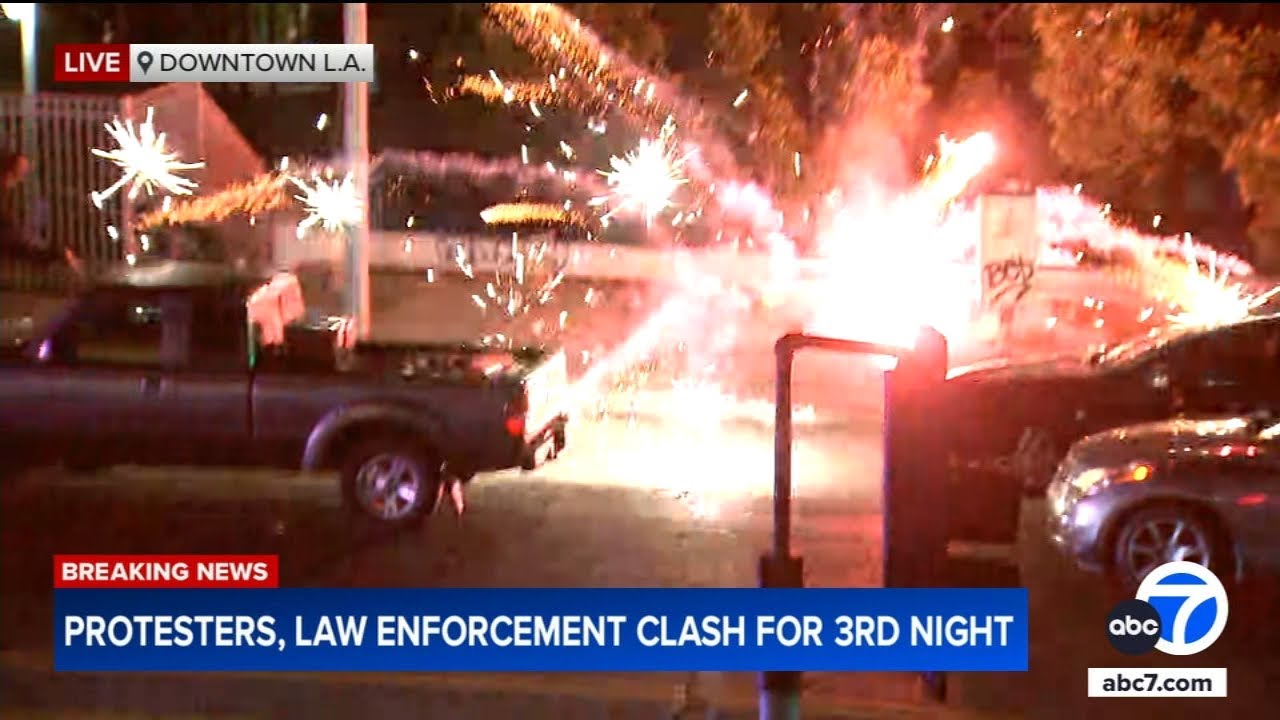 Fireworks set off during live news report of clashes in downtown LA