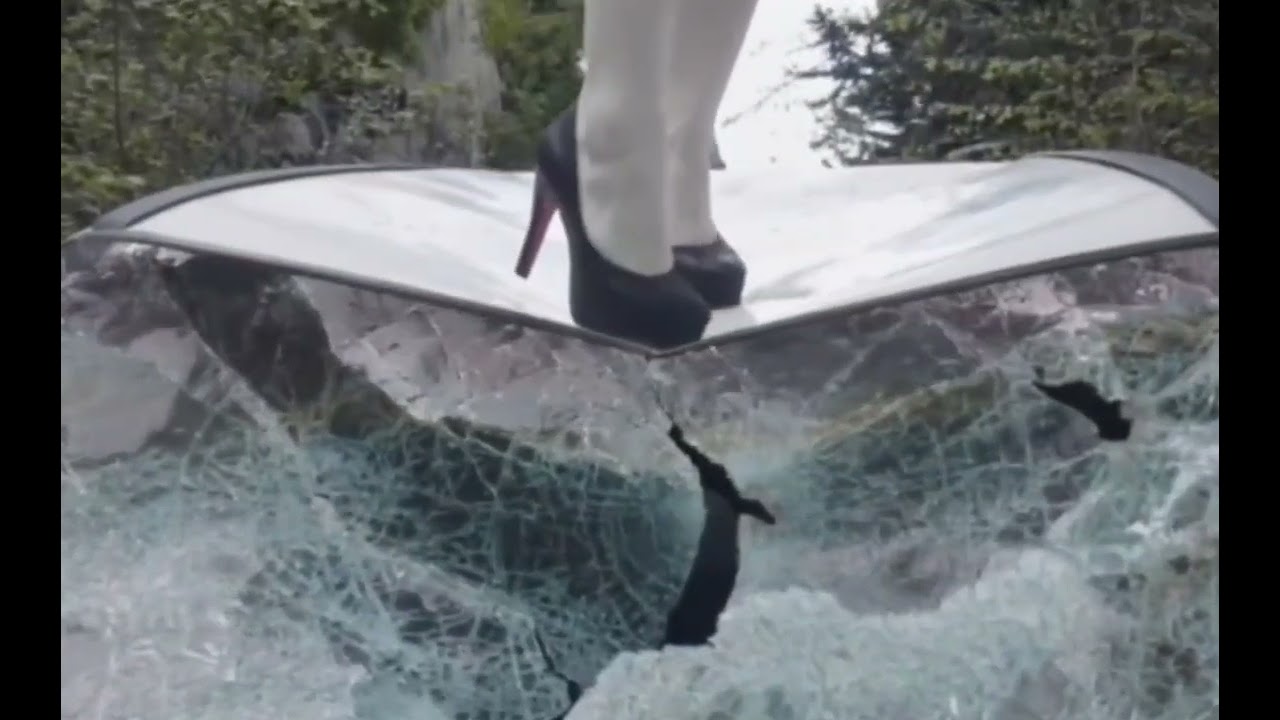 Girl in high heels trample broken car.