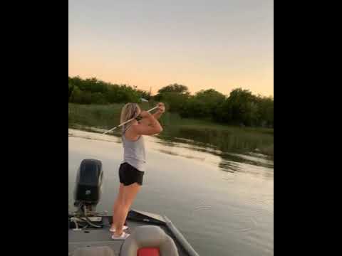 Girl tries to cast, but hooks the boat instead.