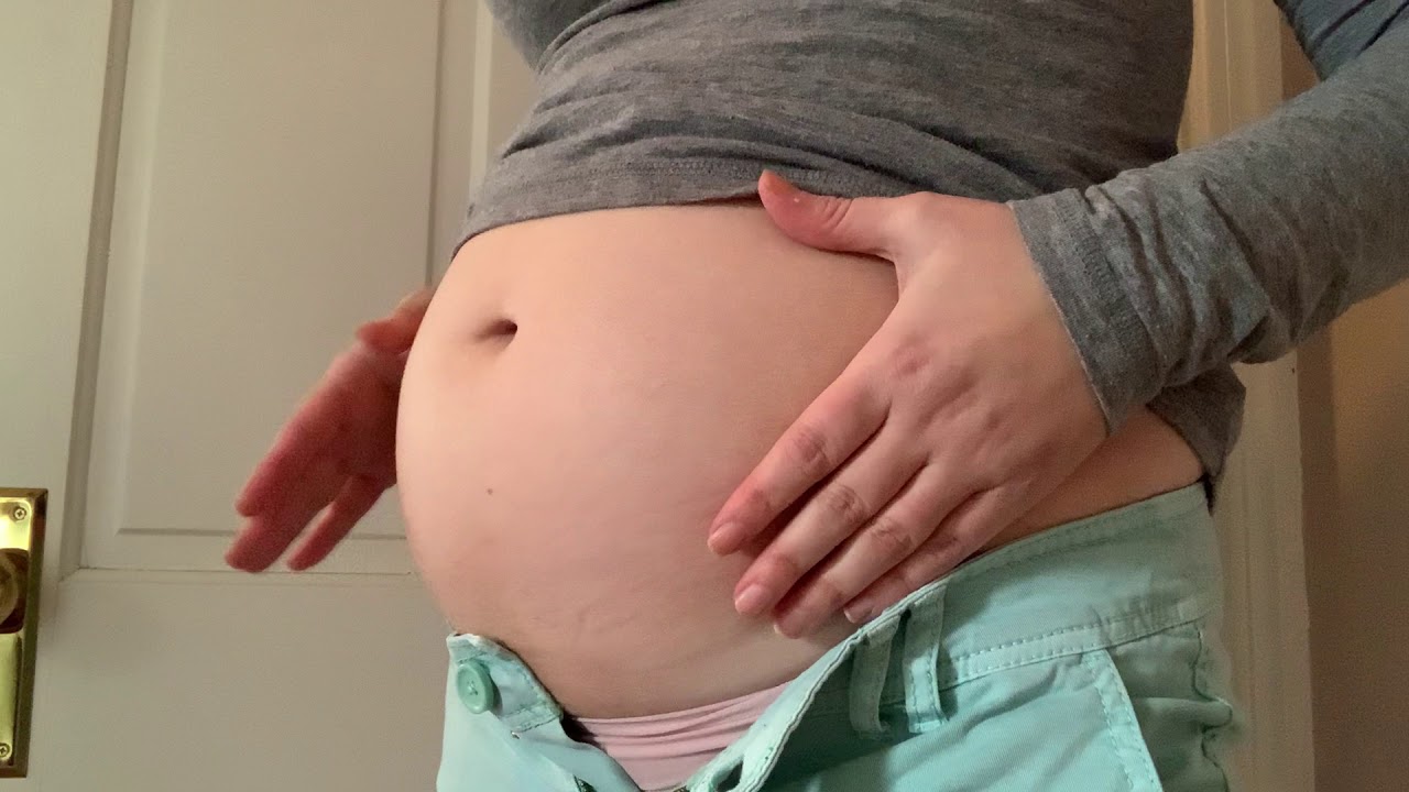 Growing belly playing in tight clothes
