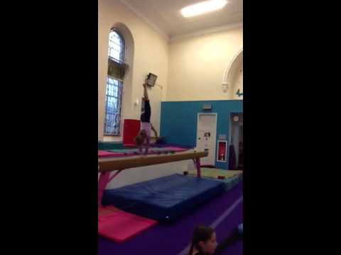 Gymnastics  Bryony doing her backward walkover flick divider on beam!!  Bryony Ludlow aged 7 years