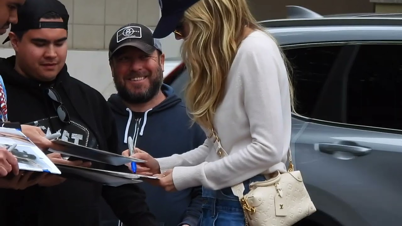 Heidi Klum in denim skirt and white long boots arriving at @AGT in Los Angeles