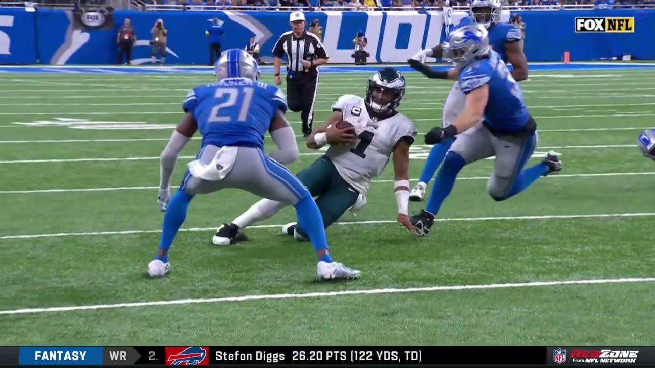 Jalen Hurts gets hit while sliding