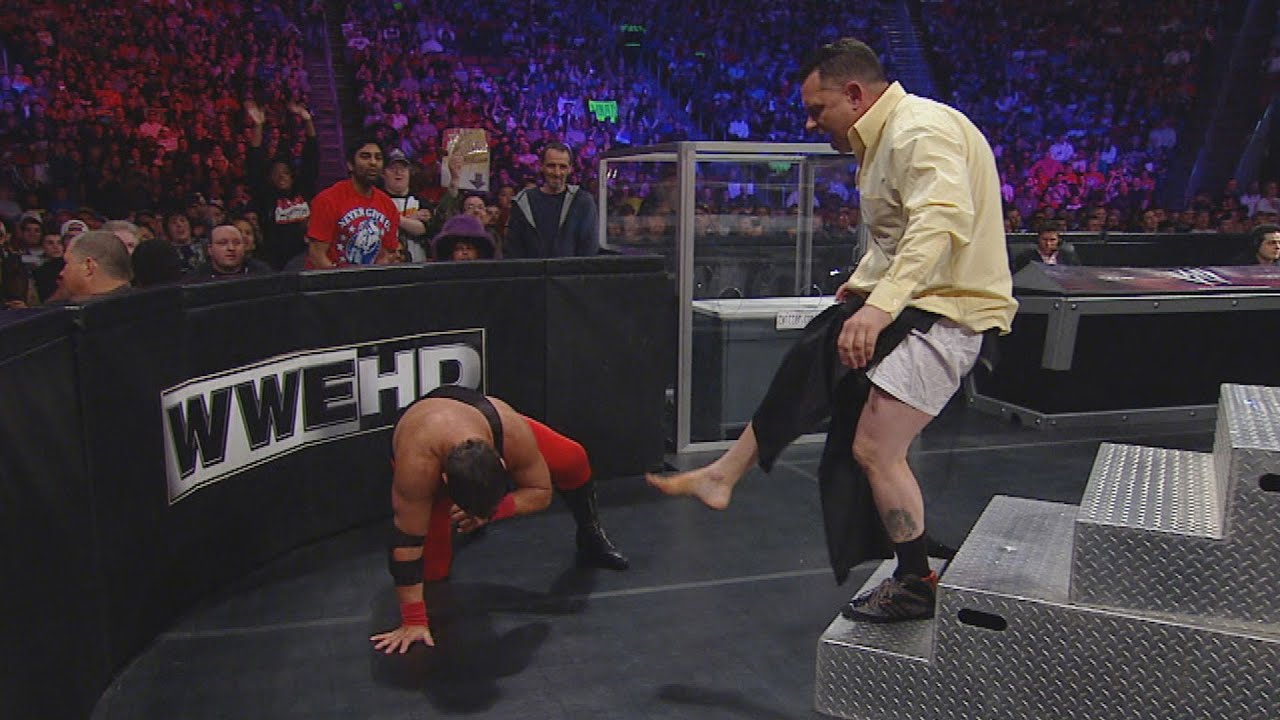 Jerry Lawler sends Michael Cole crashing into the 