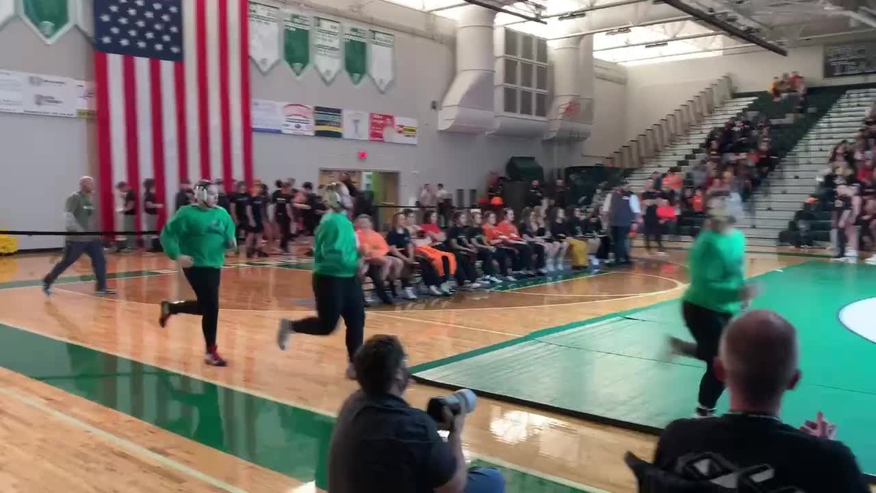 Kelly Walsh wrestlers run onto the mat prior to the inaugural Sarah Tolin Memorial Dual on Thursday