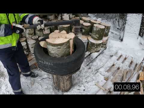 Klapien tekoa kirveellä, apuna autonrengas-halkomapölli. Splitting firewood with a tire.