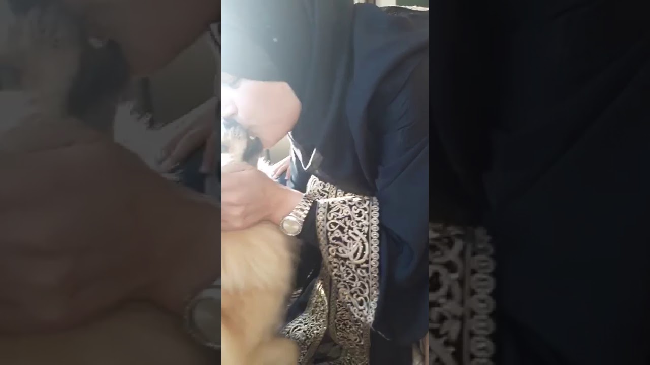 Muslim women Kissing dog