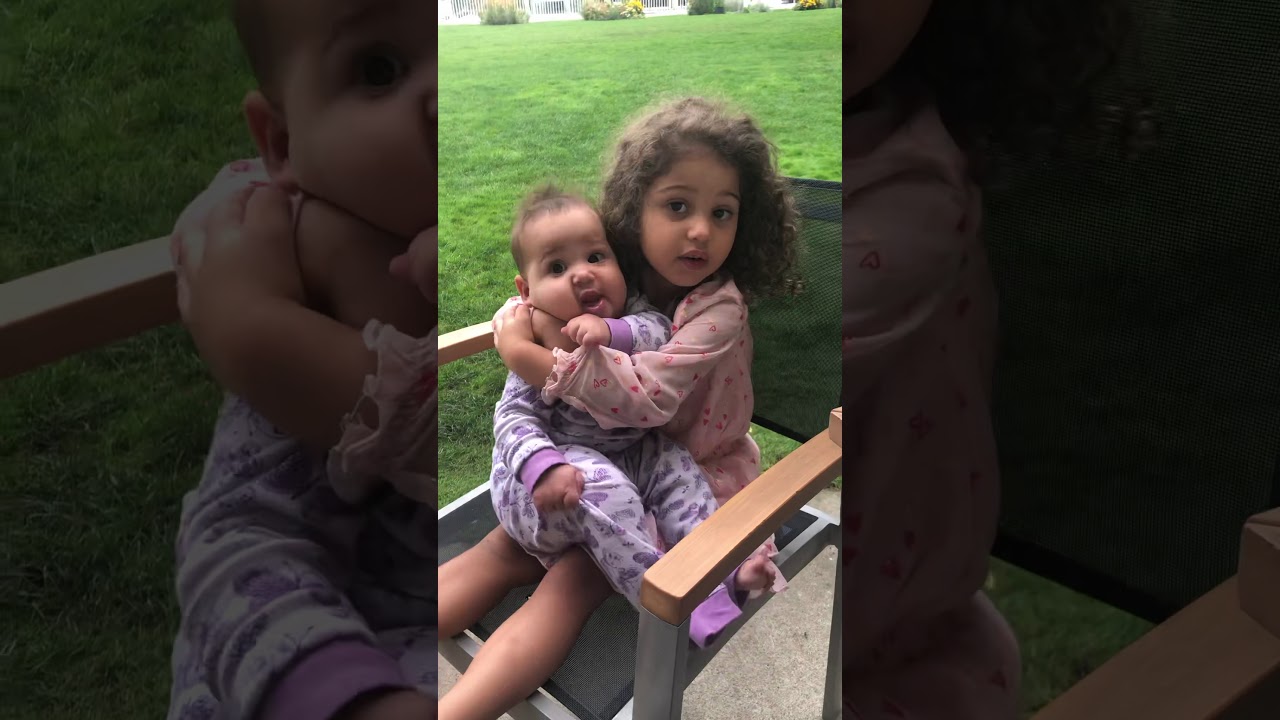 My little Dana kissing her little sister Alisha