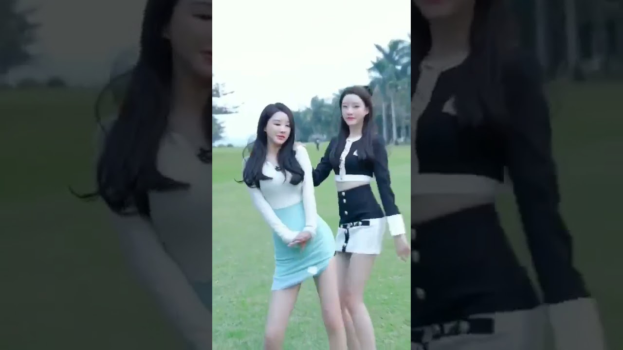 OMG OMG OMG 2 sexy Chinese girls are dancing in the grass wearing cute super mini skirt.
