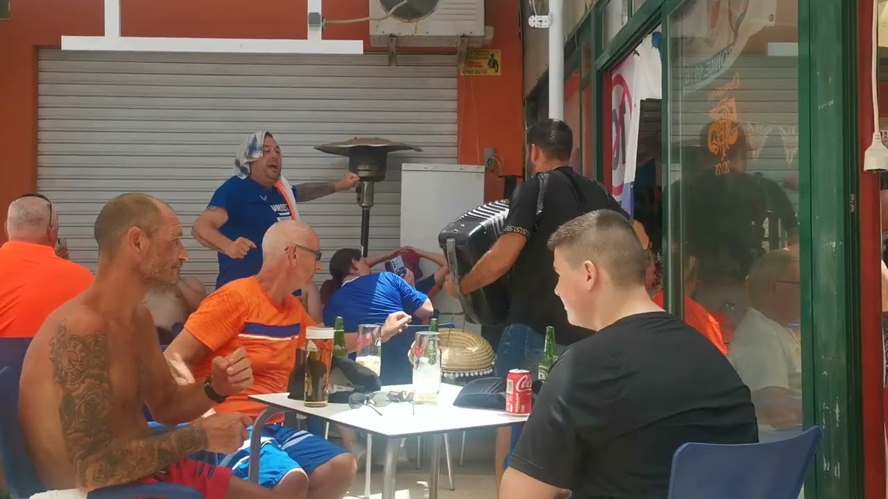Penny Arcade in Benidorm in Rangers bar with a Spanish busker
