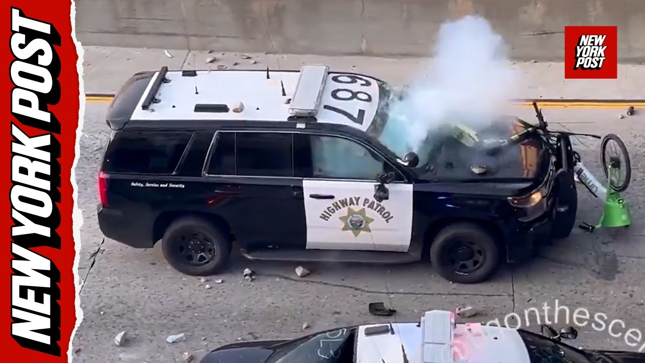Rioters bombard police from overpass – hurling rocks, fireworks and scooters