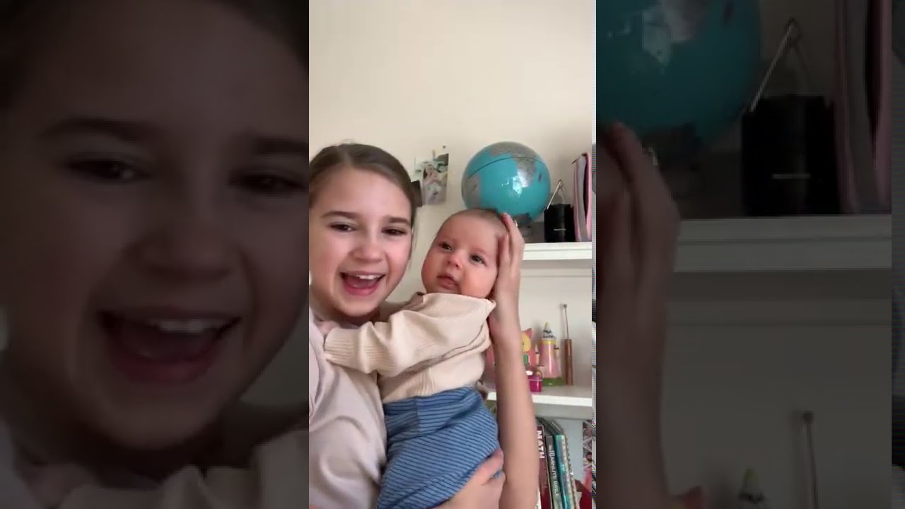 Sister singing for her newborn baby brother