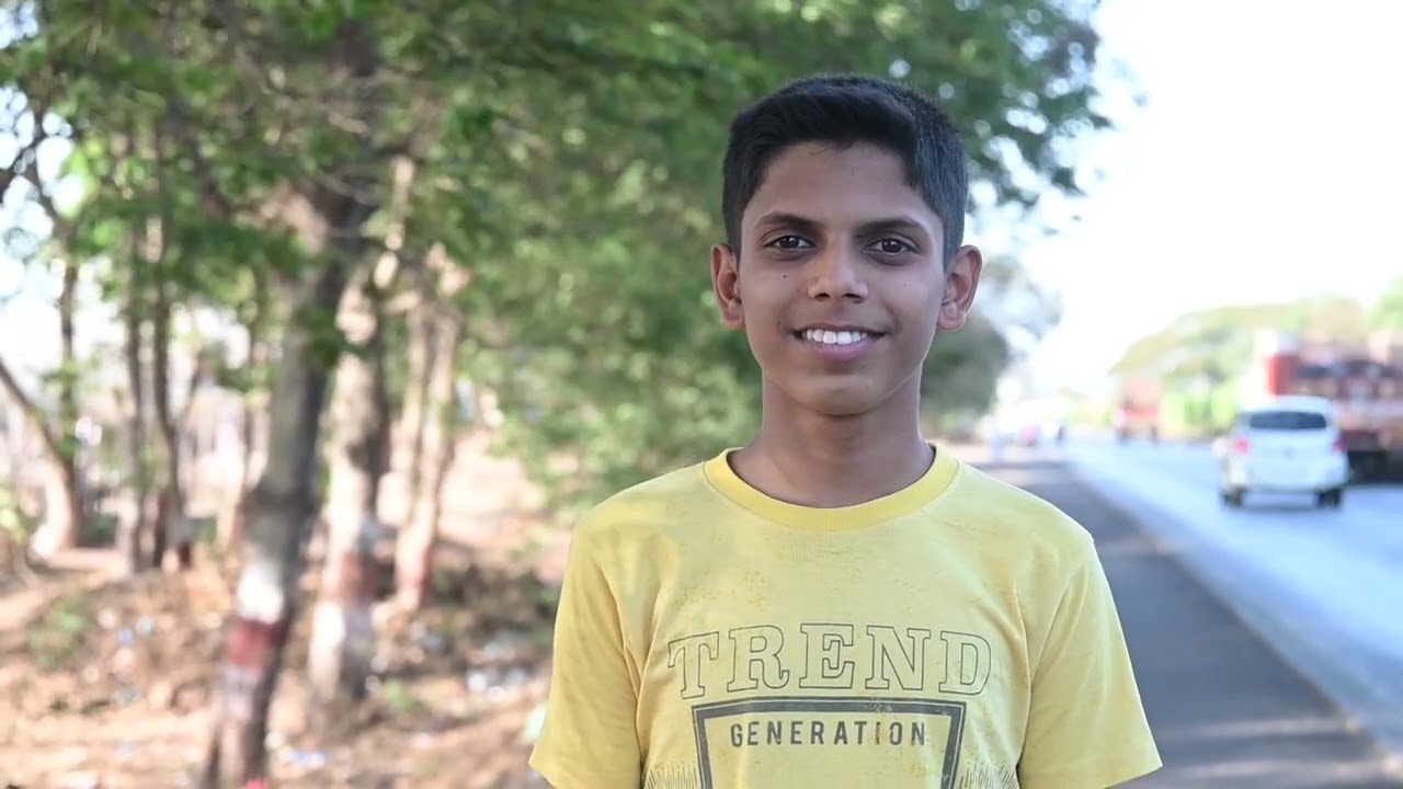 smiling Indian teen boy.  teenager in summer park at day.