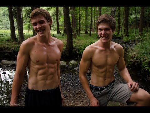 Teen athletes Ryan and Luke flexing in the woods