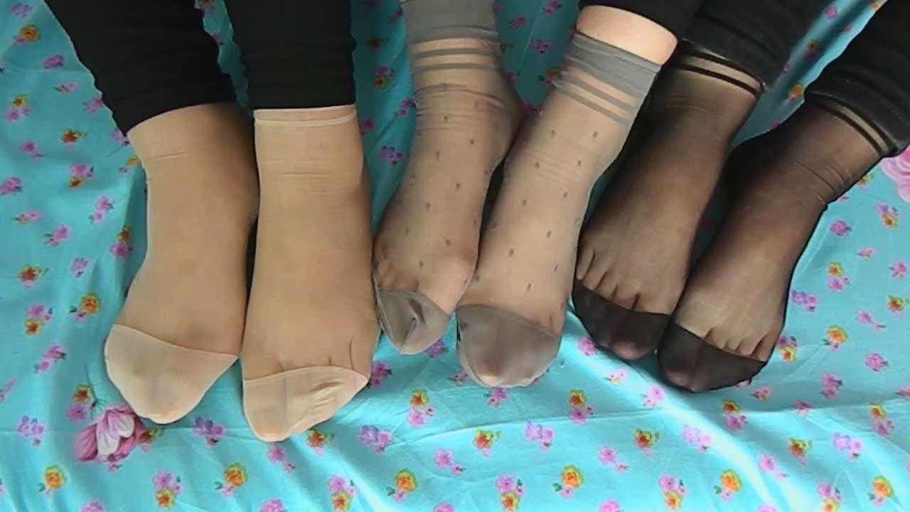 The three show their bare feet in silk stockings