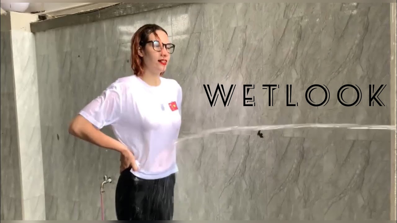 Wetlook69 Kris watering from a hose